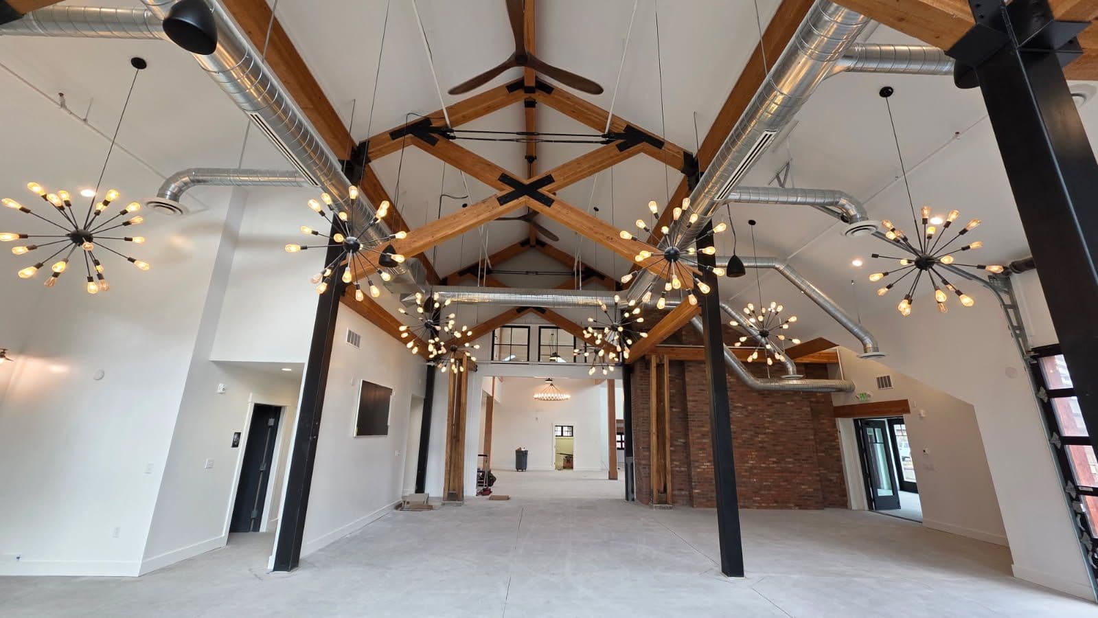 Modern Industrial Interior with Exposed Beams and Ductwork