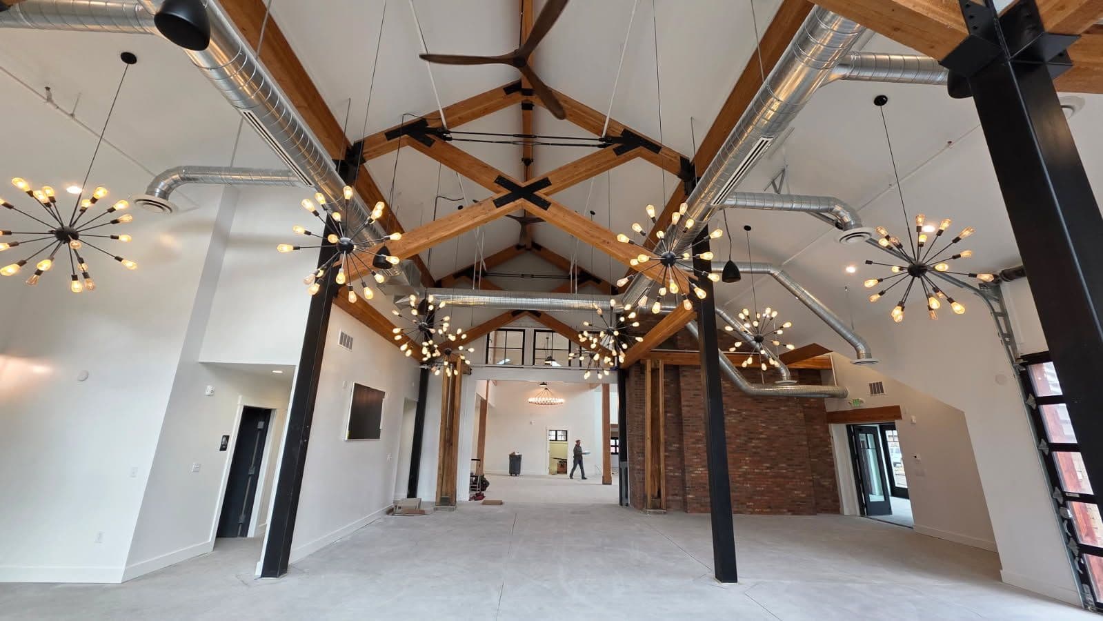 Modern Industrial Interior with Exposed Beams and Ductwork