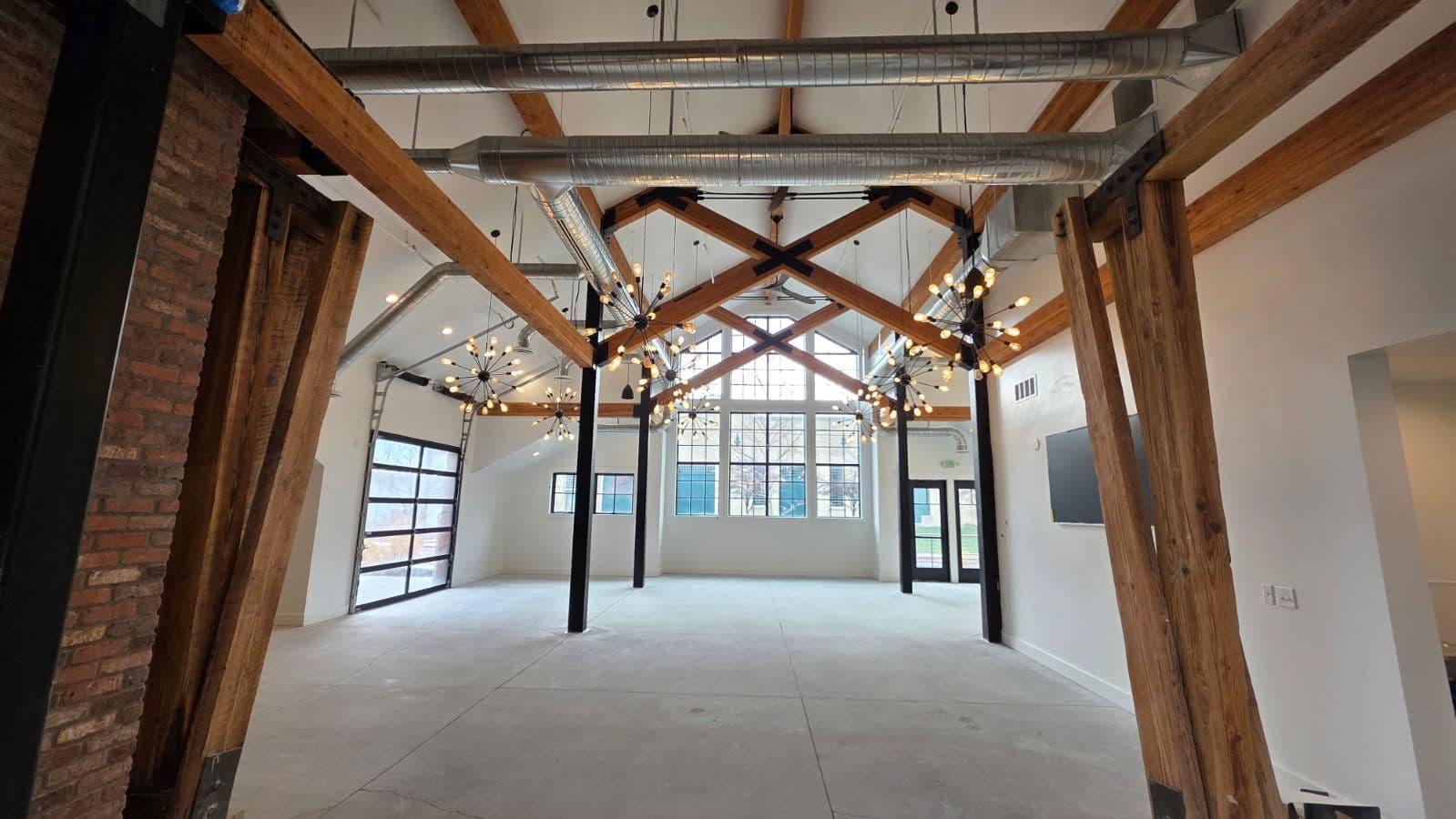 Modern Industrial Interior with Exposed Beams and Ductwork